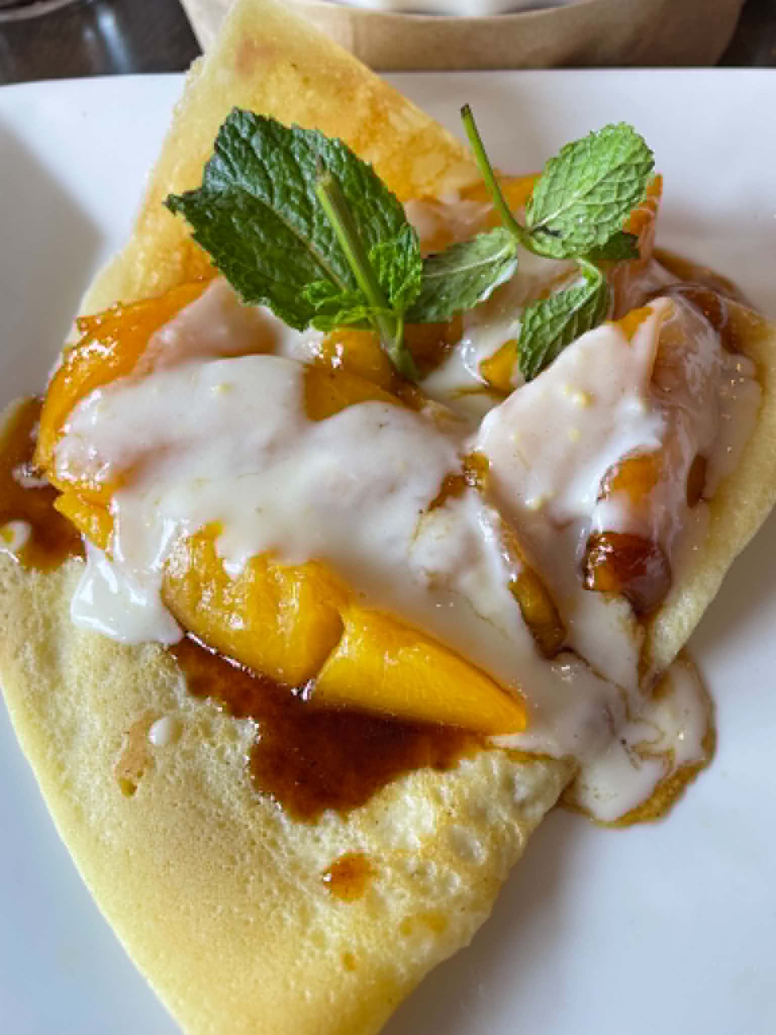 Caramelized fruit crepes with crème anglaise at Clafoutis