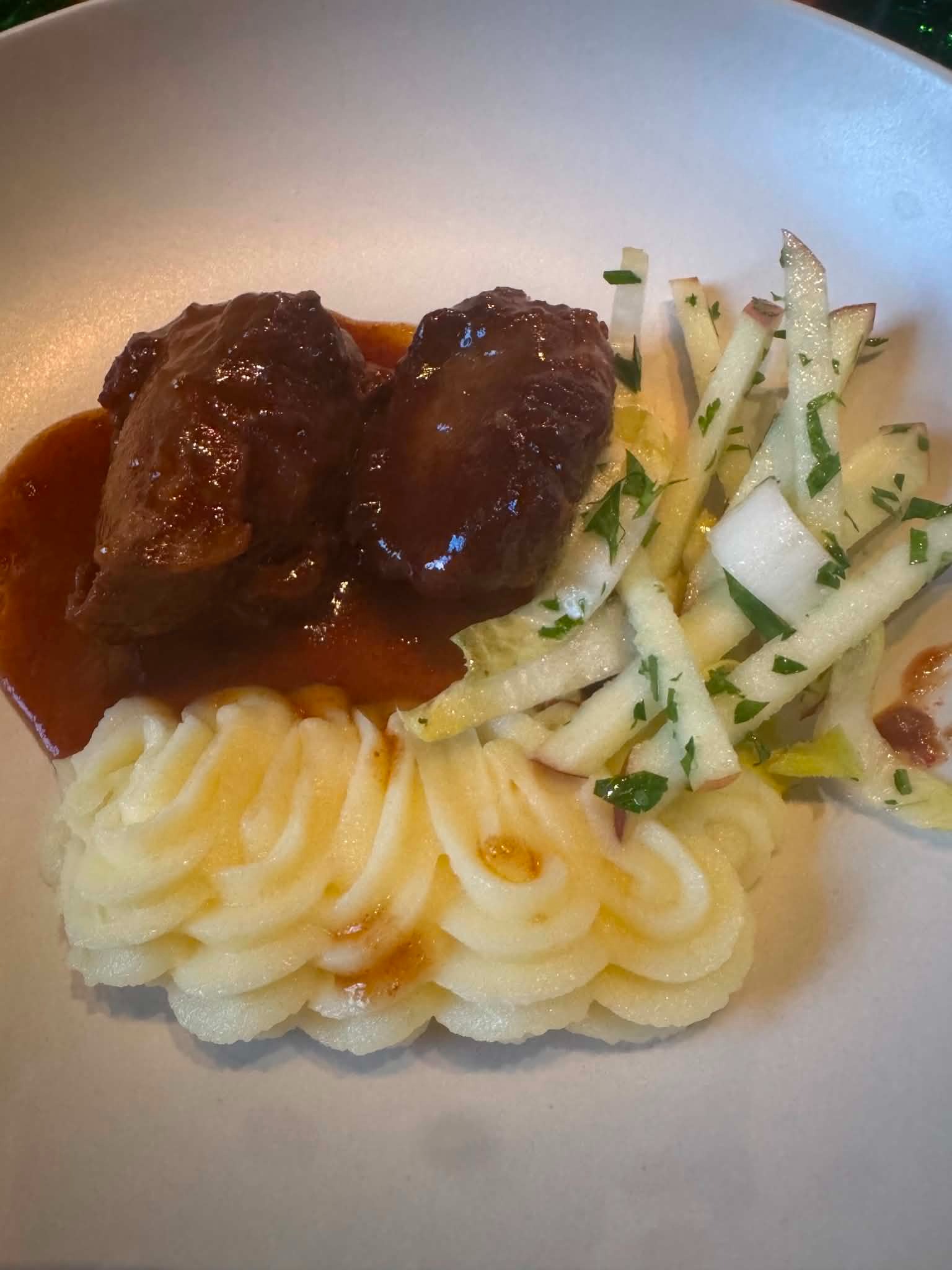 Braised meat over piped mashed potatoes with an apple matchstick salad — from Dale's first road-trip meal